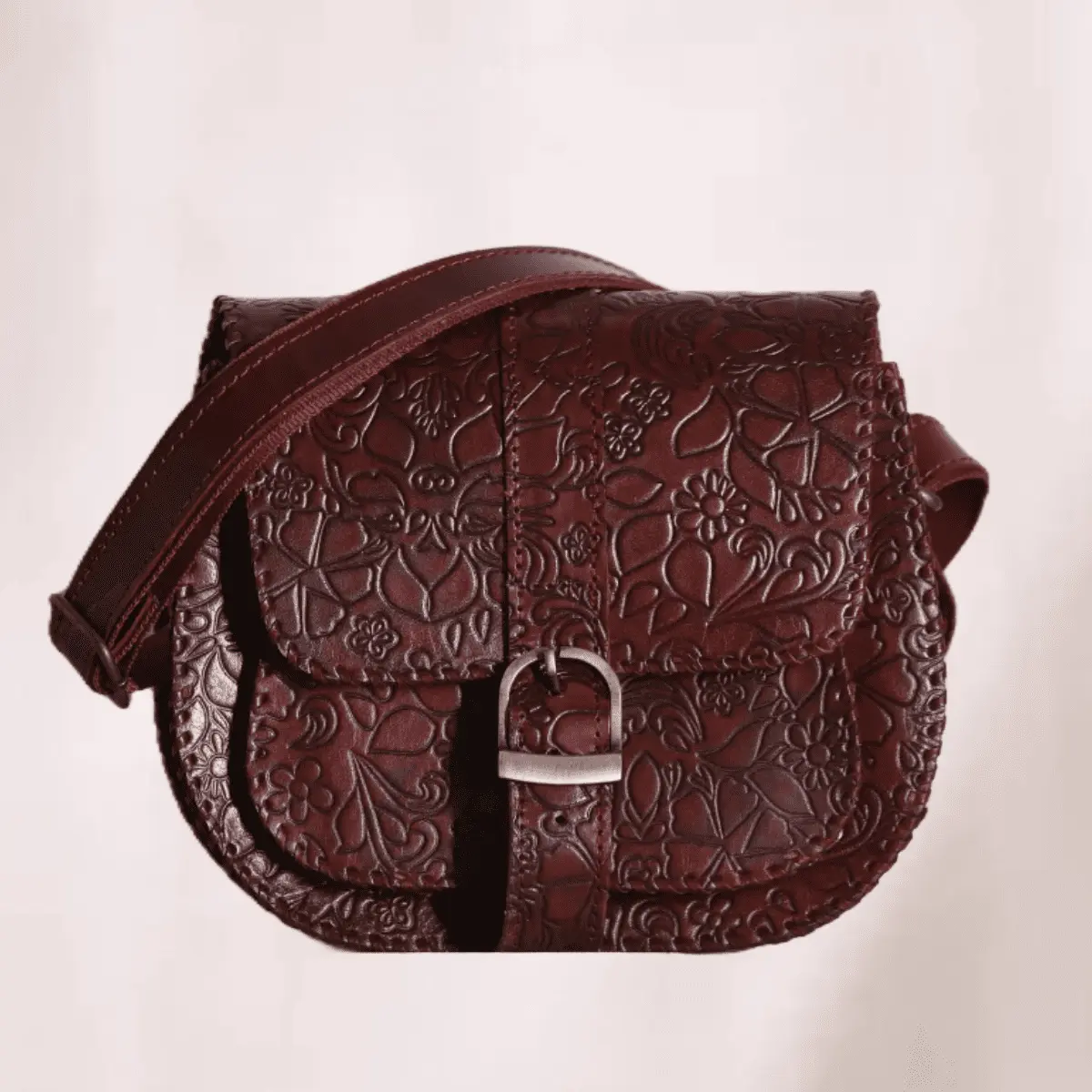 Classic deep reddish-brown hand carved leather sling bag