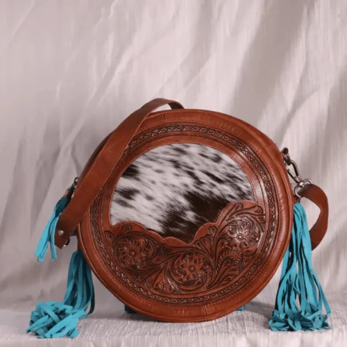 Round Cowhide hand carved leather bag with tassels.